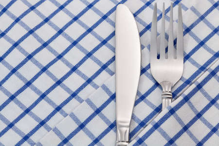 Fork and knife on napkin backgroundの写真素材