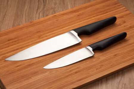 Kitchen knives on wood cutting boardの写真素材