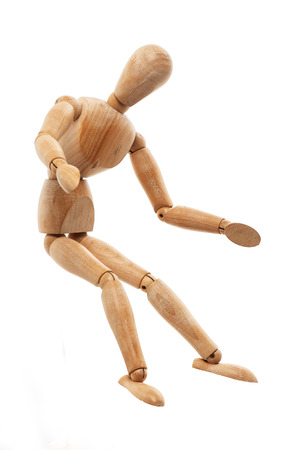 Wooden mannequin sitting pose isolated on white backgroundの写真素材