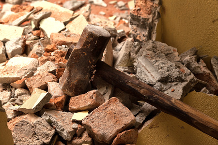 Old wood hammer on broken brick wallの写真素材
