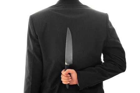 Businessman Holding Knife Behind His Back conceptual image Isolated