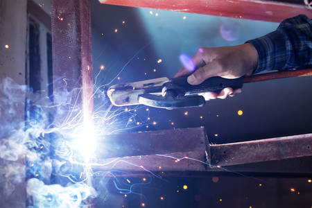 welding steel with spread spark lighting smokeの写真素材