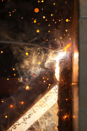 welding steel with spread spark lighting smoke