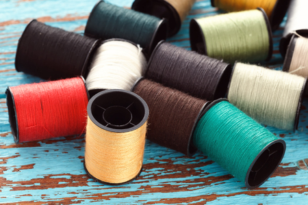 colorful thread needlework embroidery tailor craft repair background blue wood teak still life vintageの写真素材