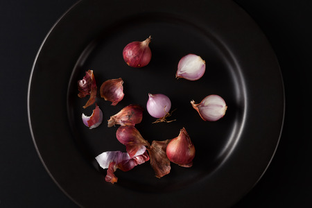 shallots still life black background onion bulb season herb vegetable ingredientの写真素材