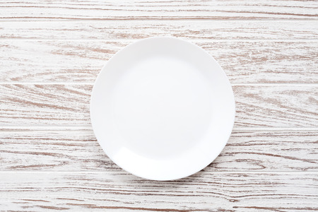 empty plate on white wooden table background still life vintage flat layの写真素材