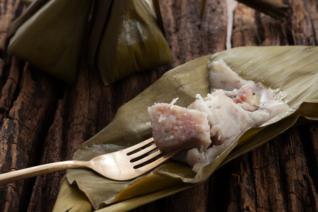 Thai dessert banana leaf tasty on wooden background still life rustic close upの写真素材