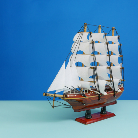 Wooden toy model of sailing vessel on a blue tone background. 2の写真素材