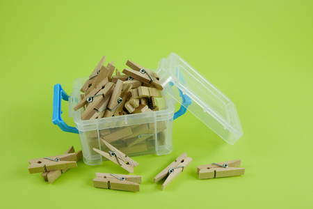 Wood clothespins in mini plastic box container. 1の写真素材