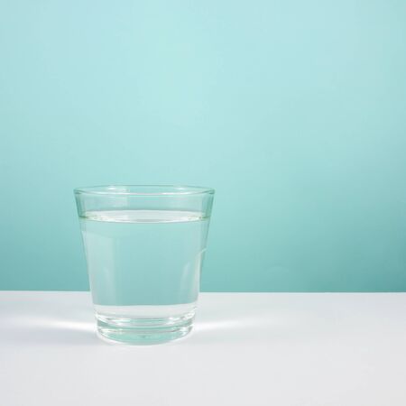 The glass of pure water on white table. 1の写真素材