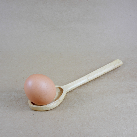 The chicken egg in the wooden spoon. 2の写真素材