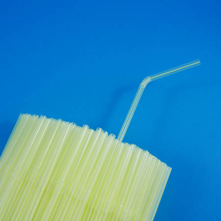 A group of yellow plastic drinking straws.の写真素材