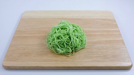 The green egg noodle on wooden chopping board. 1の写真素材