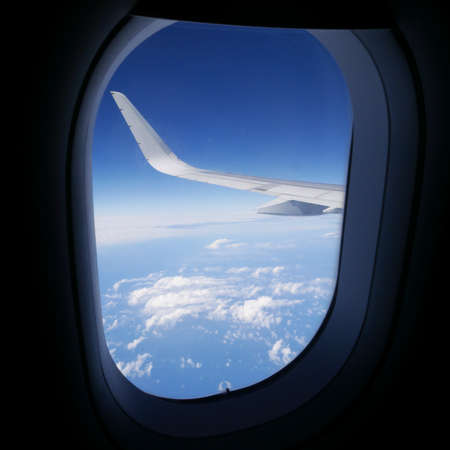 View of airplane wing and blue sky from airplane window. 1の写真素材