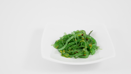Japanese seaweed salad on the white dish.の写真素材
