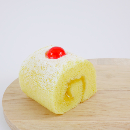 The yummy fruit jam roll on the wooden board.の写真素材