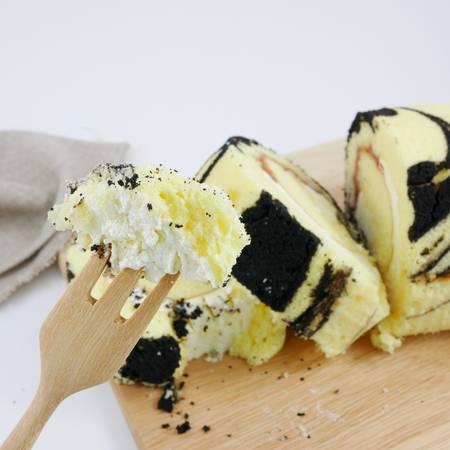 The yummy blueberry jam roll on the wooden board.