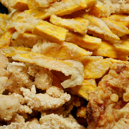 Taiwanese fried crispy sweet potato fries and deep fried popcorn chicken at food street night market.の写真素材