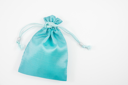 The turquoise blue silk mini gift pouch bag to hold jewelry.の写真素材