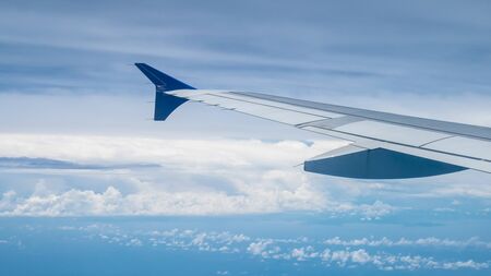 The airplane wing on the beautiful cloudy and sky.の写真素材