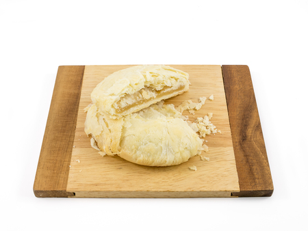 The Taiwanese sun cake (milk butter pastry) on the brown wooden plank.