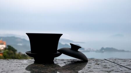 The classic Taiwanese tea cup on top of wall with sea view at Jiufen old street in Taiwan.の写真素材