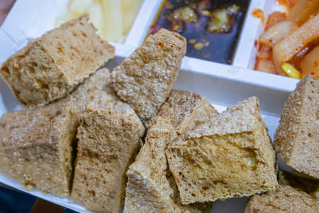 Stinky tofu, a close up of Taiwanese traditional deep fried beancurd street food at Taipei night market in Taiwan.の写真素材