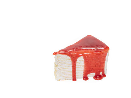 Strawberry crepe cake, a close up of homemade sliced layer cake with strawberries jam sauce topping isolated on white background.の写真素材