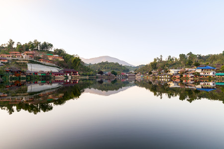 Countryside village and mountain reflection on water in northern Thailandの写真素材