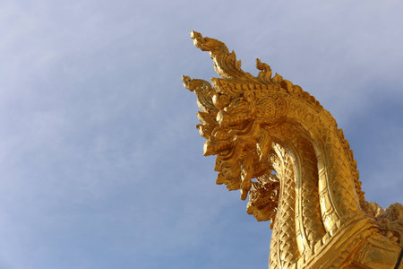 Golden dragon  statue  with  a bright sky.の写真素材