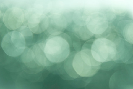 Green and white bokeh lights defocused, abstract Vintage Bokeh circles for Christmas and New year backgroundの写真素材