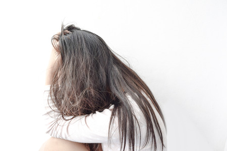 Women depression  and holding her head in her handsの写真素材
