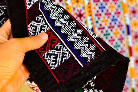 Hand-embroidered Yao Mien embroidery textile with colorful patterns, traditional tribal textile craft, intricate needlework, perfect for backgrounds, designs, and cultural art projects.の写真素材
