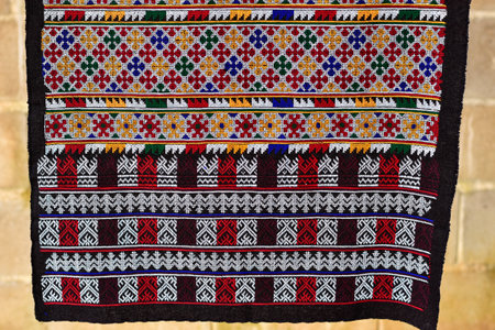 Hand-embroidered Yao Mien embroidery textile with colorful patterns, traditional tribal textile craft, intricate needlework, perfect for backgrounds, designs, and cultural art projects.の写真素材