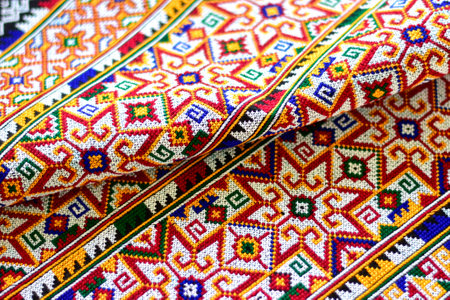 Hand-embroidered Yao Mien embroidery textile with colorful patterns, traditional tribal textile craft, intricate needlework, perfect for backgrounds, designs, and cultural art projects.の写真素材