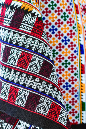 Hand-embroidered Yao Mien embroidery textile with colorful patterns, traditional tribal textile craft, intricate needlework, perfect for backgrounds, designs, and cultural art projects.の写真素材