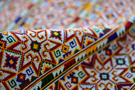Hand-embroidered Yao Mien embroidery textile with colorful patterns, traditional tribal textile craft, intricate needlework, perfect for backgrounds, designs, and cultural art projects.の写真素材