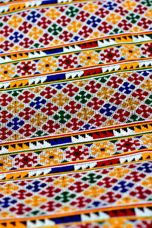 Hand-embroidered Yao Mien embroidery textile with colorful patterns, traditional tribal textile craft, intricate needlework, perfect for backgrounds, designs, and cultural art projects.の写真素材