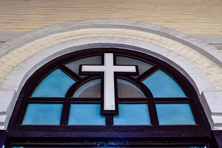 Cross on Stained glass window in a churchの写真素材