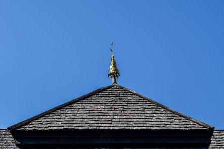 Detail of the roof of a church with a golden dome against the blue skyの写真素材