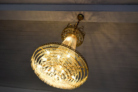 Luxury chandelier hanging on the ceiling in the roomの写真素材