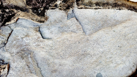 Close-up of a natural mountain rock surface featuring rough and organic textures. Ideal for use in backgrounds, design elements,の写真素材