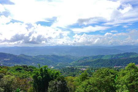 Scenic Mountain Landscape with Blue Sky and Layers of Misty Hills
