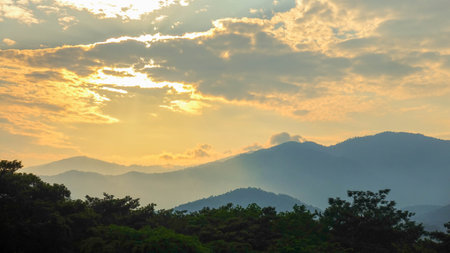 Sunset Over Mountain Layers with Dramatic Skyの写真素材