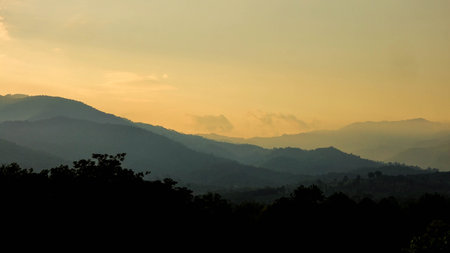 Sunset Over Mountain Layers with Dramatic Skyの写真素材
