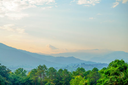 Sunset Over Mountain Layers with Dramatic Skyの写真素材