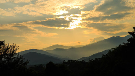 Sunset Over Mountain Layers with Dramatic Skyの写真素材