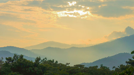 Sunset Over Mountain Layers with Dramatic Skyの写真素材