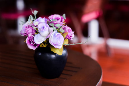 Flowers made of pink fabrics in a Vase on blown Table. in coffee shop, vintage color toneの写真素材