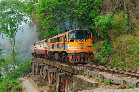 Kanchanaburi, Thailand - MARCH 21, 2015: The train running through the Death Railway in Kanchanaburi, Thailand. Thailand-Burma Railway built by the Empire of Japan in 1943 on World War II.のeditorial素材